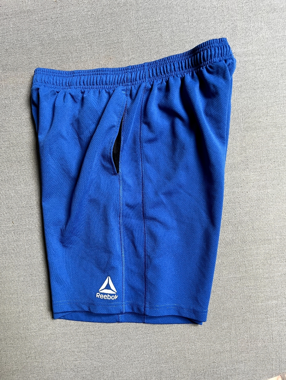 Reebok Men's Royal Blue Athletic Shorts with Logo, Size Large.